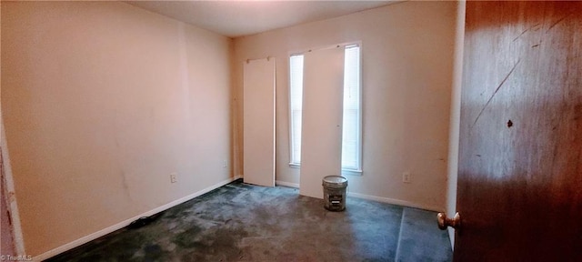 305 Corliss St, Greensboro, NC 27406 - empty room with healthy amount of natural light, carpet, and baseboards