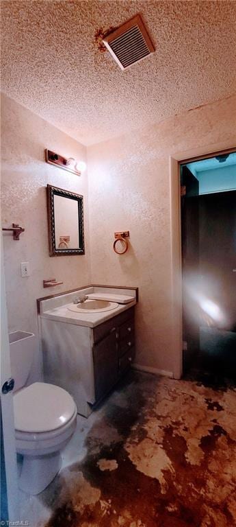 305 Corliss St, Greensboro, NC 27406 - half bath featuring a textured ceiling, vanity, and toilet