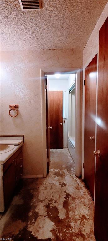 305 Corliss St, Greensboro, NC 27406 - bathroom with a textured ceiling and vanity
