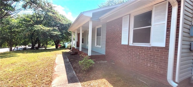 305 Corliss St, Greensboro, NC 27406 - view of home's exterior with a lawn and brick siding