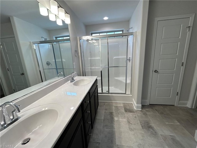 bathroom featuring vanity and a shower with door