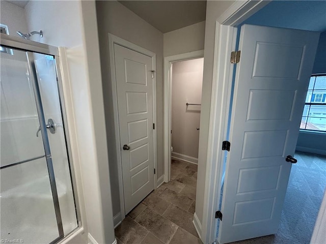 bathroom with toilet and walk in shower