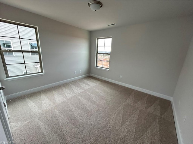 empty room with light colored carpet