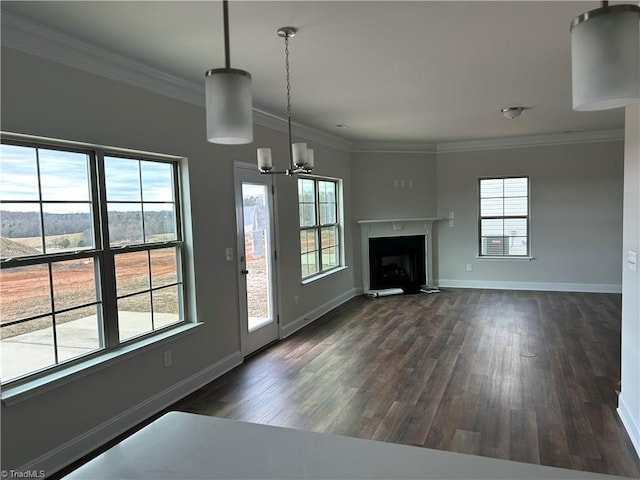 unfurnished living room with ornamental molding, dark hardwood / wood-style flooring, and a wealth of natural light