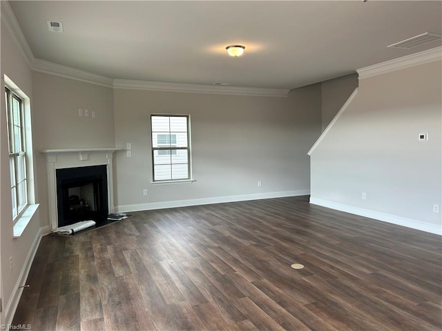 unfurnished living room featuring dark wood-type flooring and ornamental molding