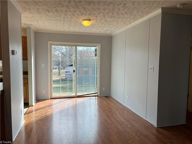 unfurnished room with crown molding, hardwood / wood-style floors, and a textured ceiling