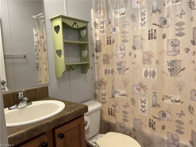 bathroom with tasteful backsplash, vanity, walk in shower, and toilet