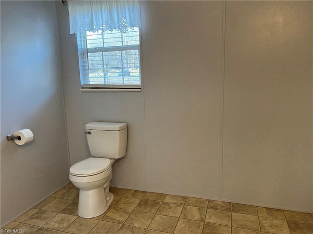 bathroom featuring tile patterned flooring and toilet