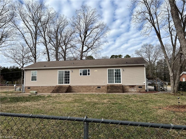 rear view of house with a lawn