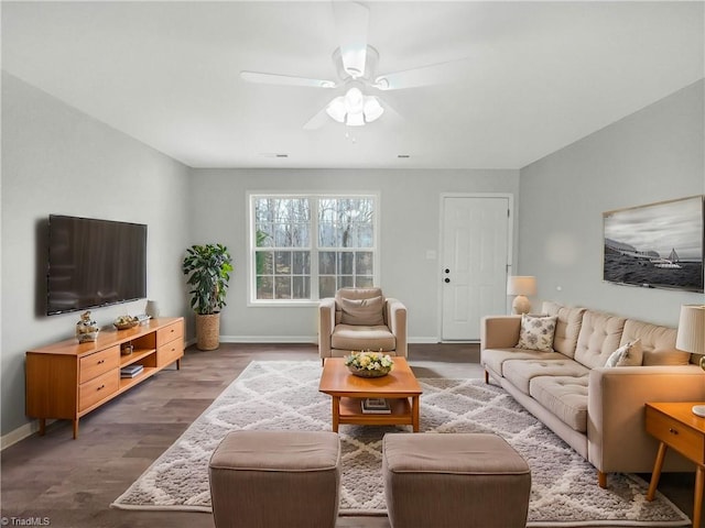 living room featuring wood-type flooring and ceiling fan