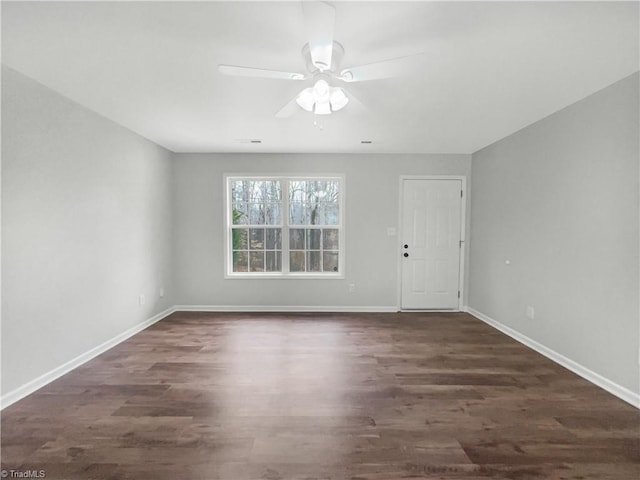 spare room featuring ceiling fan and dark hardwood / wood-style floors