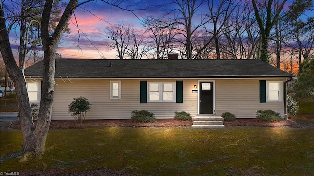 single story home featuring a yard and a chimney