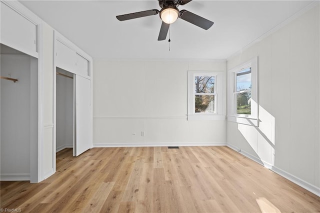 unfurnished bedroom with crown molding, a ceiling fan, light wood-type flooring, and visible vents