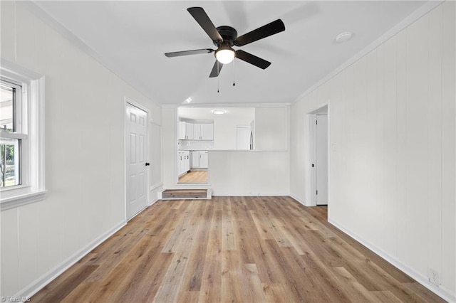 unfurnished living room with light wood-style flooring and a ceiling fan