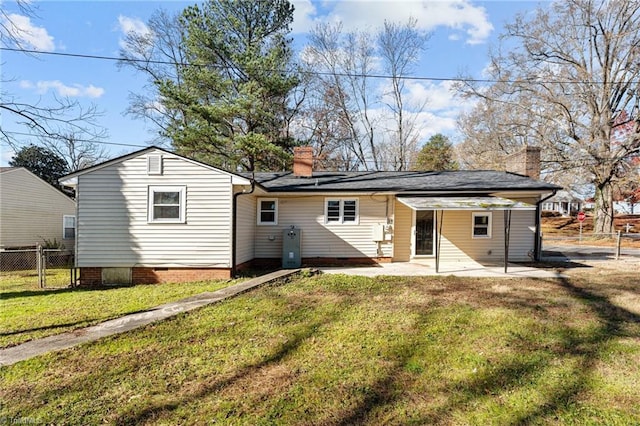 back of property featuring fence, a patio area, a chimney, a yard, and crawl space