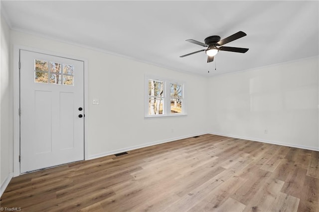 foyer with light wood-type flooring, visible vents, ornamental molding, baseboards, and ceiling fan