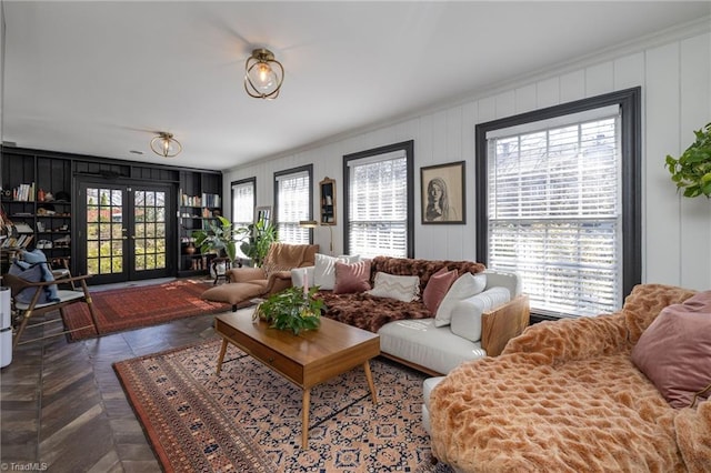 living area with french doors and ornamental molding