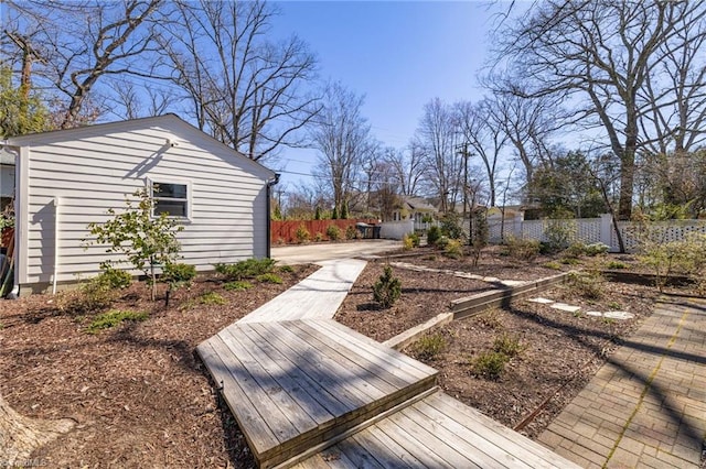 view of yard featuring an outdoor structure and fence