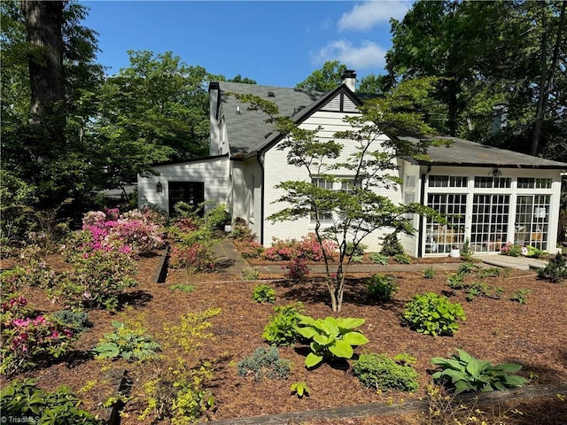 view of side of property with a sunroom