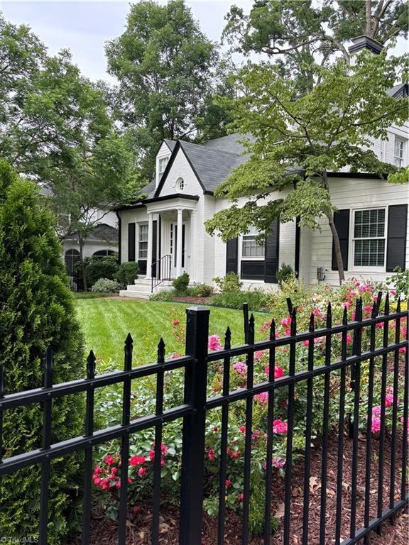 view of front of house with a fenced front yard and a front lawn