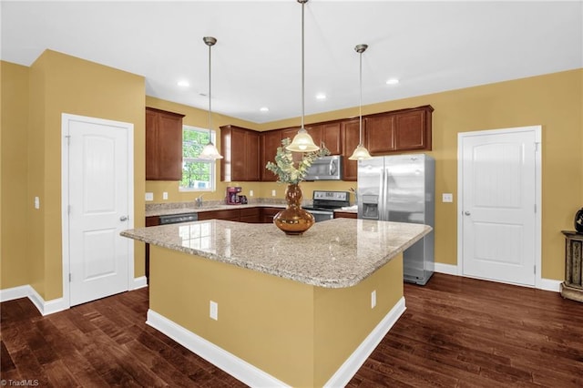 kitchen featuring a kitchen island, stainless steel appliances, light stone countertops, and dark wood-style flooring
