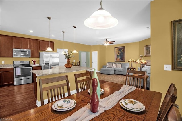 dining space with ceiling fan, recessed lighting, and dark wood-type flooring