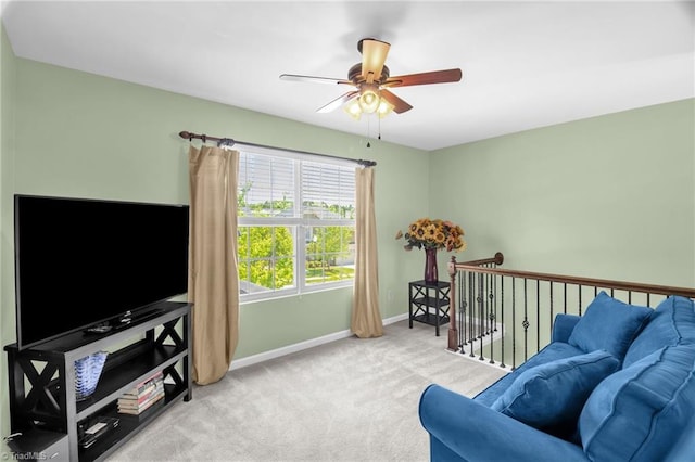 carpeted living room with baseboards and ceiling fan