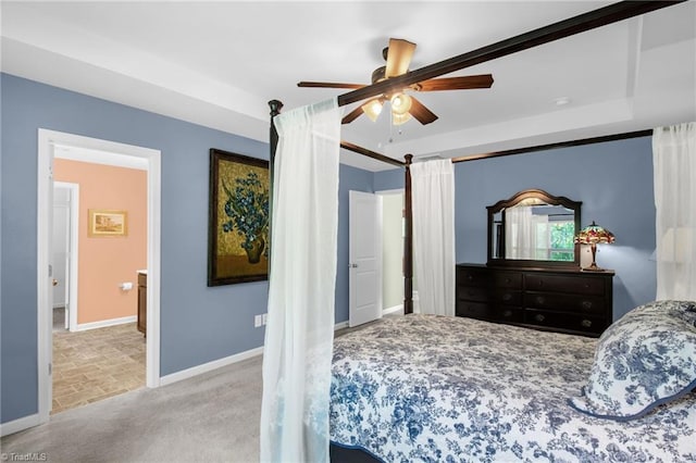 bedroom featuring a raised ceiling, baseboards, ceiling fan, and carpet