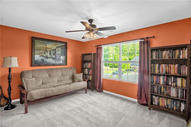 living area featuring baseboards, carpet flooring, ceiling fan, and visible vents