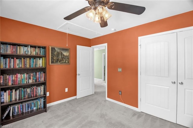 bedroom featuring ceiling fan, carpet, attic access, baseboards, and a closet