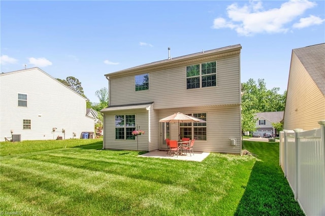 rear view of house featuring a patio, a lawn, and central AC
