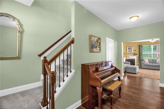 staircase featuring baseboards and wood finished floors