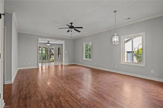 spare room featuring wood-type flooring, ceiling fan, and crown molding