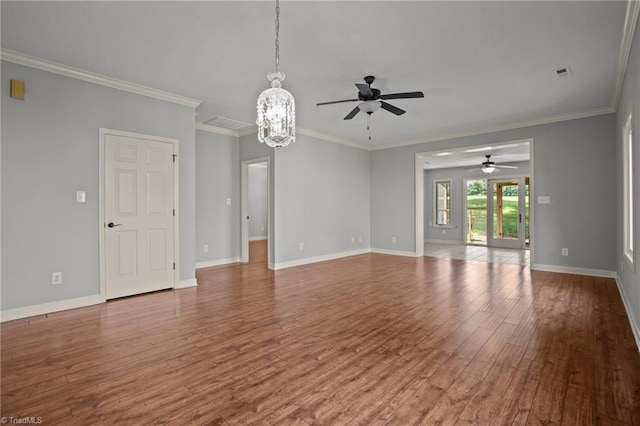 unfurnished living room with ceiling fan with notable chandelier, hardwood / wood-style flooring, and crown molding