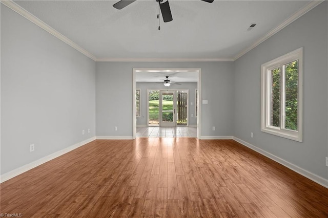 unfurnished living room with a healthy amount of sunlight, ornamental molding, and light hardwood / wood-style flooring