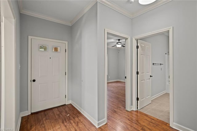 foyer entrance with ceiling fan, light hardwood / wood-style flooring, and ornamental molding