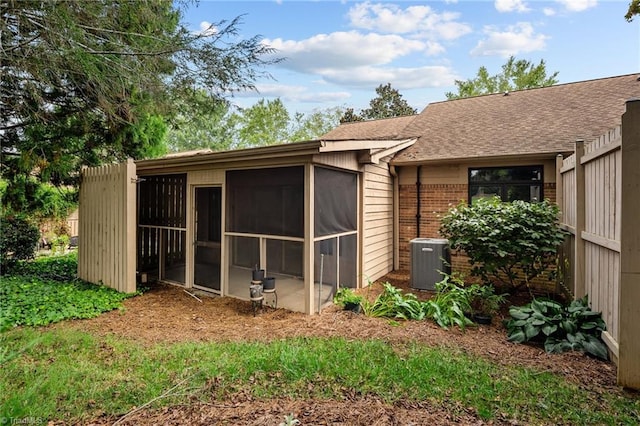 exterior space with a sunroom and cooling unit