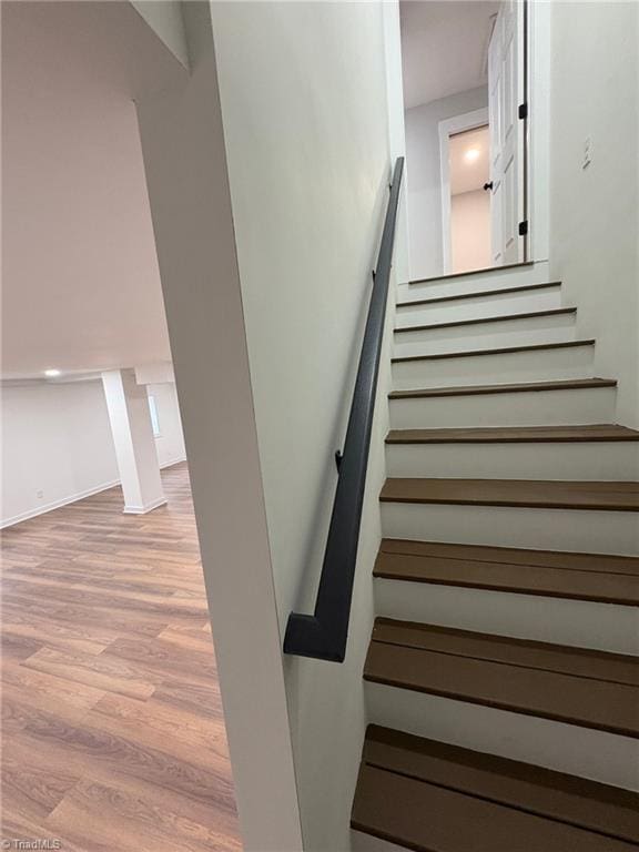 staircase with wood finished floors