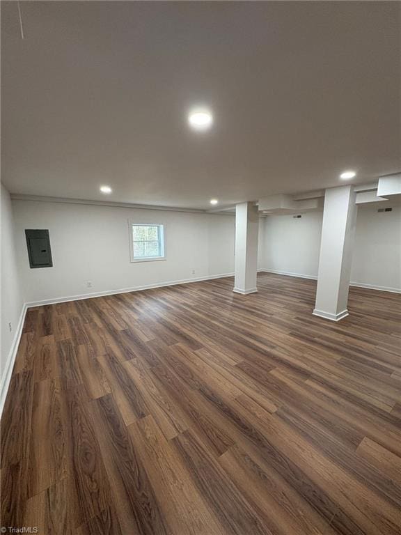 below grade area with baseboards, dark wood-type flooring, and recessed lighting