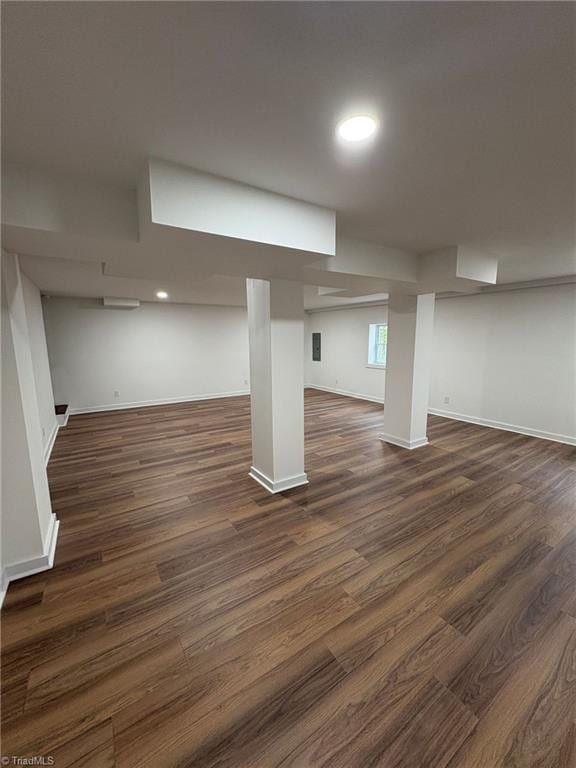 below grade area featuring dark wood-style flooring, recessed lighting, and baseboards