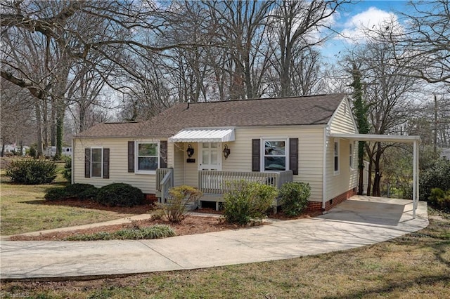 view of front of home with driveway, a shingled roof, a carport, a front lawn, and crawl space