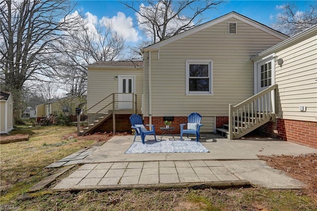 rear view of property featuring crawl space, entry steps, and a patio