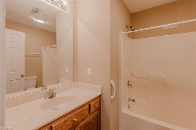 full bathroom featuring toilet, shower / bath combination, visible vents, and vanity