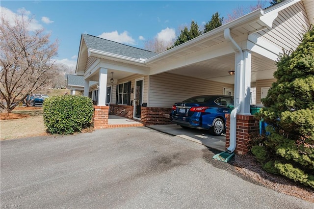 view of vehicle parking with an attached carport and driveway