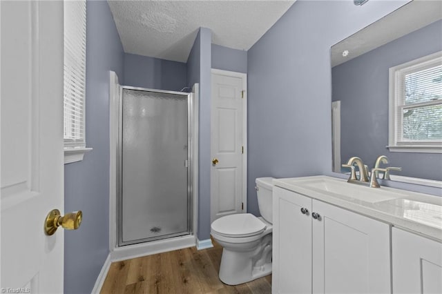 bathroom with vanity, a textured ceiling, wood-type flooring, toilet, and an enclosed shower