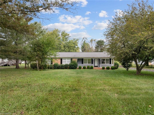 ranch-style home with a porch and a front lawn