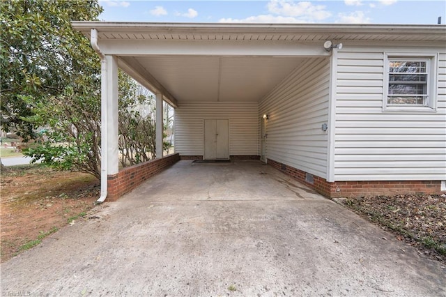 view of parking / parking lot featuring a carport and concrete driveway