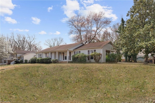 ranch-style home featuring a porch and a front yard