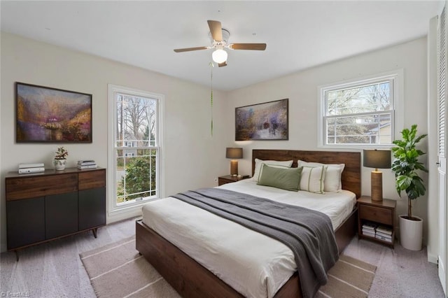 bedroom featuring light carpet and ceiling fan