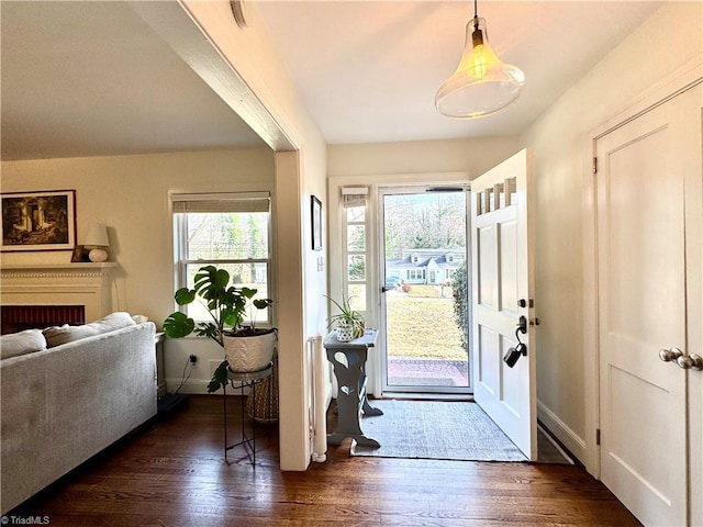 foyer entrance featuring dark wood-style floors and baseboards